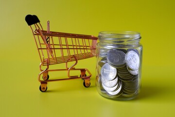 trolley and coins in a jar with a yellow background