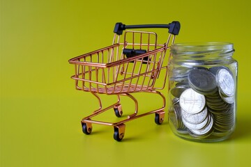 trolley and coins in a jar with a yellow background