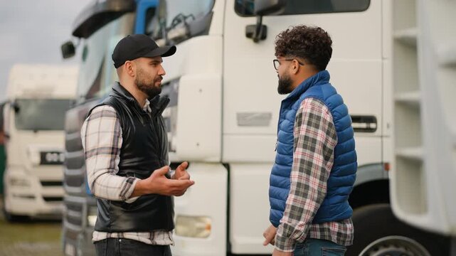 Two truck drivers shaking hands after a successful deal