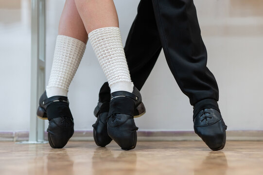 Close-up of female and male legs dancing traditional Irish stepdance. 