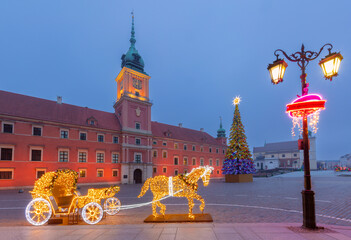 Illuminated Christmas carriage decorations on a cobblestone street in Old Town Warsaw Poland