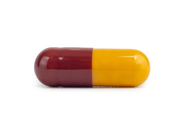 A single maroon and yellow medical capsule pill isolated on a clean white background. 