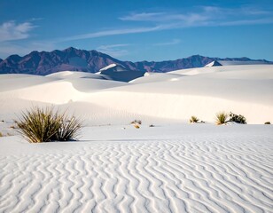 Sunny desert vista of white sand dunes under a bright blue sky