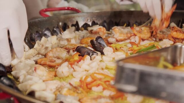 魚介料理　ムール貝と海老野菜と米を大きな鍋で煮込んだ料理　パエリア・レストラン大鍋料理　湯気を上げる食事