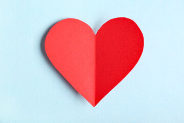 Fototapeta premium Red paper heart on blue background. Valentine's Day celebration