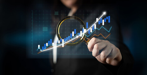 A business person examines digital graphs showcasing growth trends and statistical data, emphasizing strategic analysis and performance insights in a modern business context. Impute