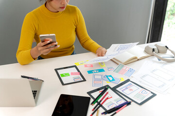 Asian adult woman UX UI designer creative application mobile website development planning digital user interface experience prototyping modern workspace