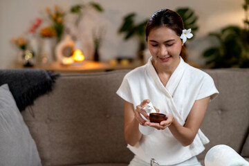 Asian adult woman prepare home spa beauty treatment product application self care relaxation wellness cozy living room environment