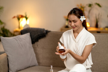 Asian adult woman self care spa ritual home applying essential oil relaxation wellness glowing skin beauty routine tranquil setting