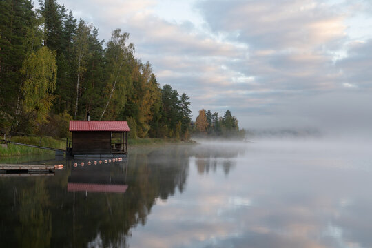 Wooden bathhouse on the shore of Lake Ladoga near the village of Lumivaara on a foggy autumn morning, Ladoga Skerries, Lahdenpohya, Republic of Karelia, Russia