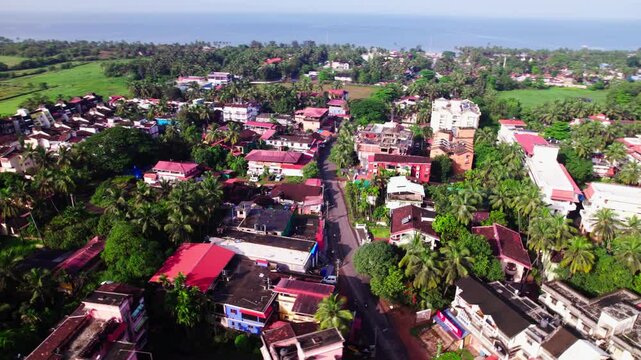 coastal village with greenery, signal tower, church and Arabian Sea at colva, goa, india. day time, circle shot, drone shot, 4k.