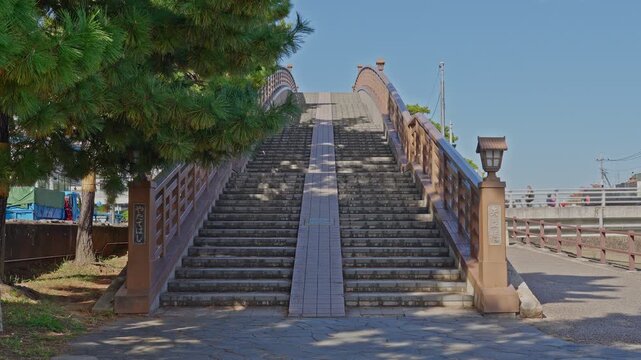 Symmetrical front view of the historic Yatate Bridge, showing the central steps and accessible ramp.