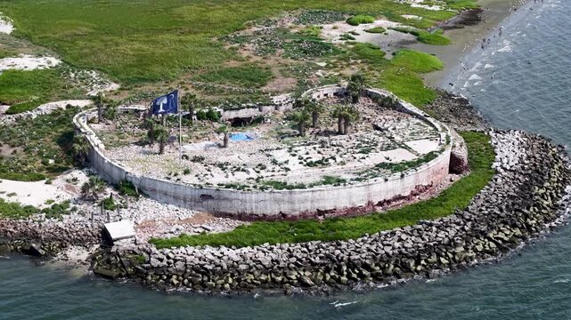 Drone footage captures Fort Sumter from above, showcasing the iconic Civil War-era sea fort surrounded by riprap breakwaters and green lawns at the entrance to Charleston Harbor