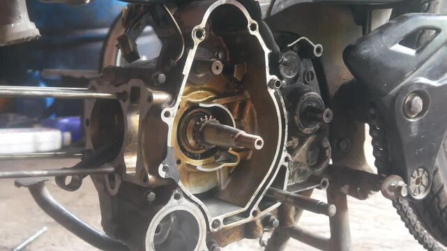 motorcycle engine being disassembled into the magnet block and cylinder sections