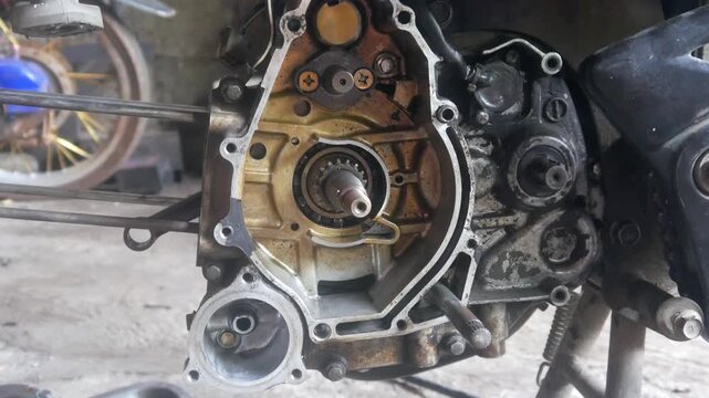 motorcycle engine being disassembled into the magnet block and cylinder sections