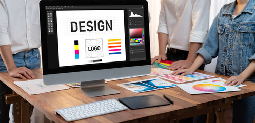Graphic designer software for modern design of web page and commercial brisk ads showing on the computer screen
