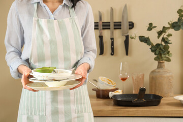 Young woman with many dirty dishes at home, closeup