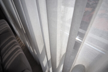 Light shining through sheer curtains in a room
