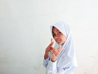 A girl in a red and white school uniform is posing in front of the camera