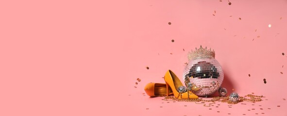 Stylish high heels with disco balls, tiara and party decor on pink background © Pixel-Shot
