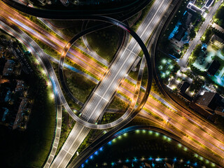 Aerial Night View of Complex Highway Interchange with Light Trails