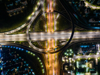 Aerial Night View of Complex Highway Interchange with Light Trails