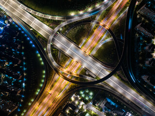 Aerial Night View of Complex Highway Interchange with Light Trails