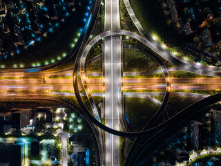 Aerial Night View of Complex Highway Interchange with Light Trails