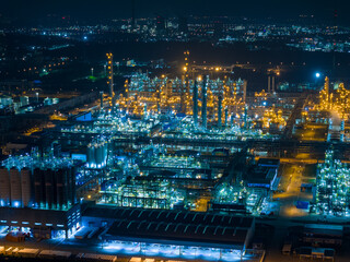 Aerial Night View of Glowing Industrial Complex with Pipelines