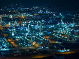Aerial Night View of Glowing Industrial Complex with Pipelines