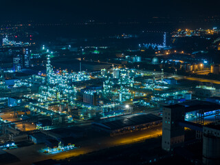Aerial Night View of Glowing Industrial Complex with Pipelines