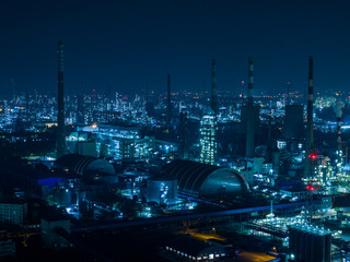 Aerial Night View of Glowing Industrial Complex with Pipelines
