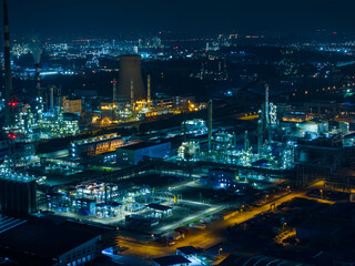 Aerial Night View of Glowing Industrial Complex with Pipelines