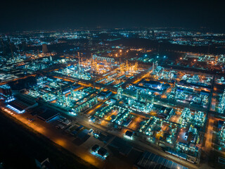Aerial Night View of Glowing Industrial Complex with Pipelines