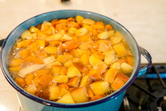 Mexican ponche navide&ntilde;o simmering in a blue pot