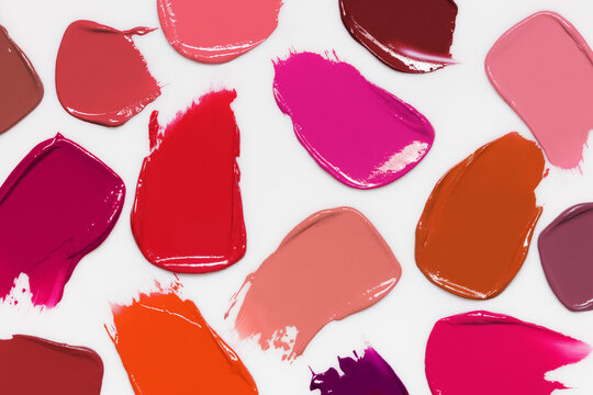 Lipstick shades swatches. Color makeup cream smudges on light gray background. Cosmetic smears collection