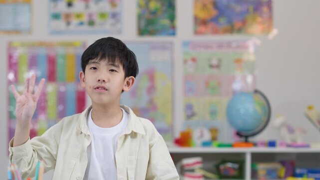 Young Student Counting on Fingers in Classroom Setting
