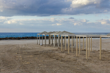  deserted beach with sunshades in December in Haifa