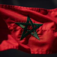 Close-up of a vibrant national banner, featuring a distinctive green five-pointed star on a rich red background, symbolizing cultural heritage and national unity