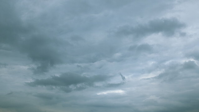 The sky is overcast and filled with moody grey clouds, creating a dramatic and soothing atmosphere