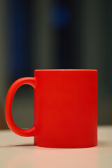 Vibrant Red Matte Ceramic Coffee Mug on Neutral Background with Bokeh