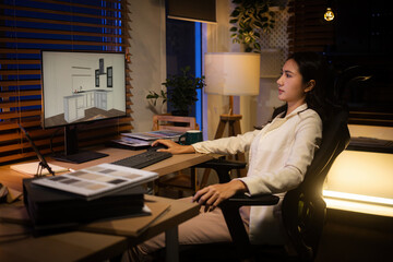 Focused interior designer evaluates digital room design, surrounded by samples and documents during late-night work