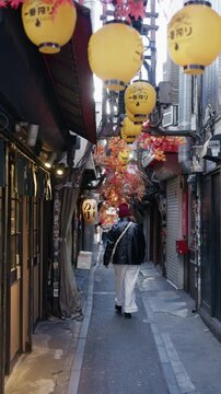 Asian women walking at Omoide Yokocho in Tokyo's Shinjuku district.Travel concept.