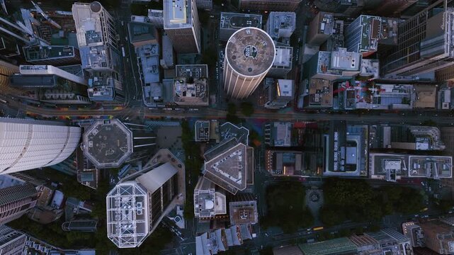 Top down drone shot above skyscrapers in downtown Sydney, sunrise in Australia