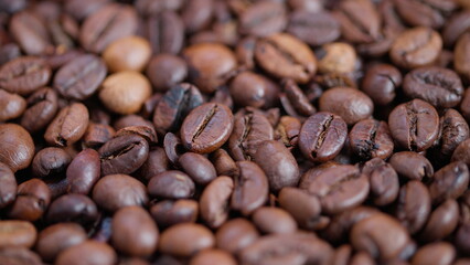Coffee bean aesthetics, Closeup shot highlighting glossy roasted coffee bean details, Detailed view emphasizing aromatic qualities and warm ambiance of roasted coffee beans
