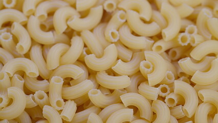 Macro elbow pasta texture with tight pattern, clean neutral background, studio lighting, high...