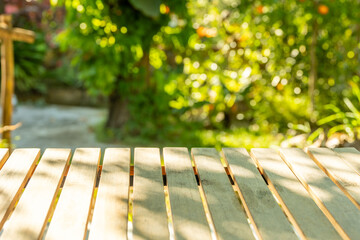wooden table space with green home garden backyard view blur background for advertising template