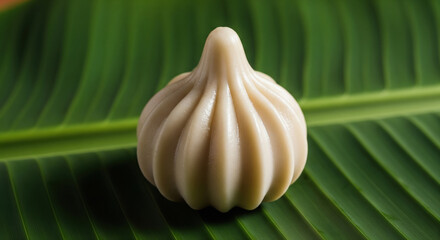 Traditional Indian Modak Sweet on Green Banana Leaf