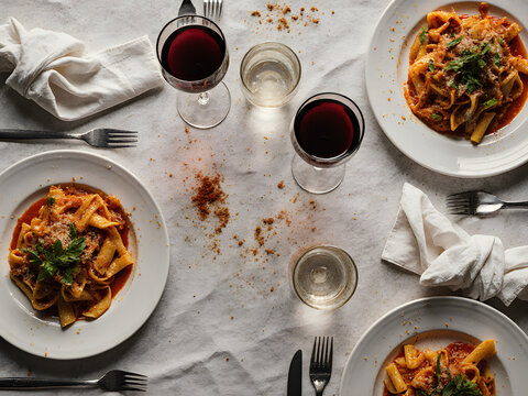 A Dinner Table with Leftover Food and Empty Glasses