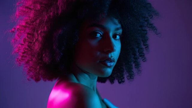Futuristic beauty portrait of a young african american female with an afro hairstyle. Triptych sequence of a model posing in vibrant pink and blue neon lights for a fashion campaign